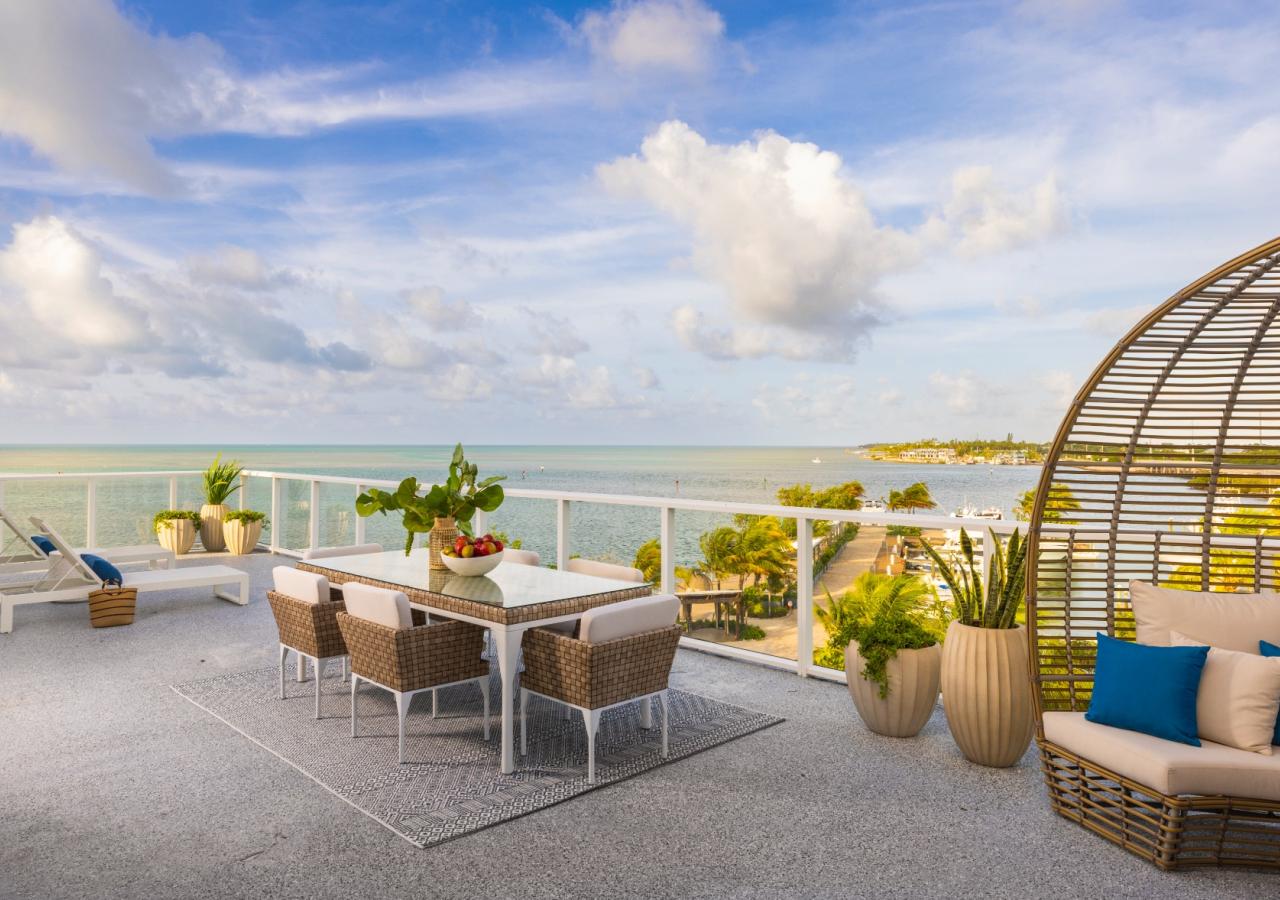 Balcony view of the Three Waters Suite with ocean views and outdoor patio furniture.