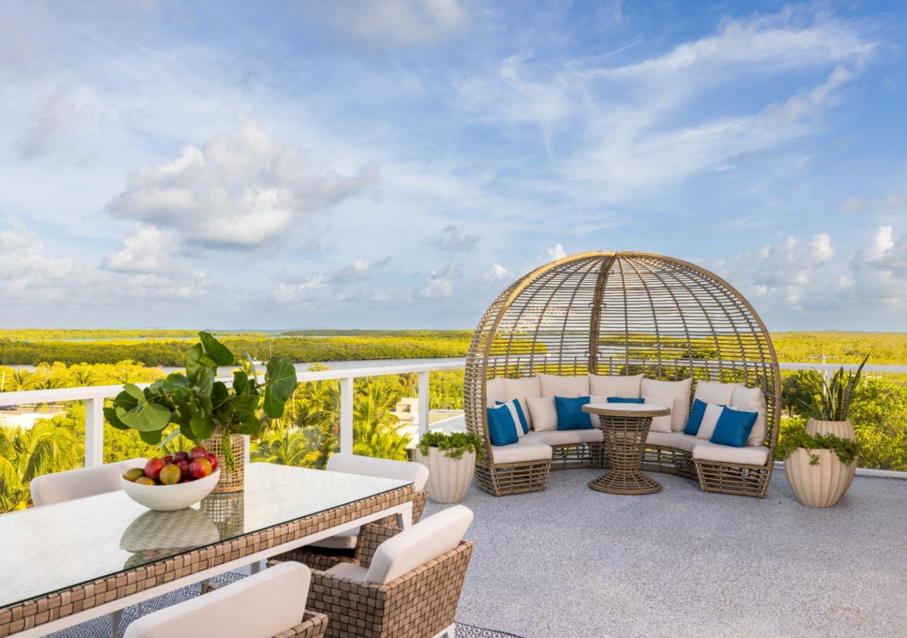 Balcony view of the Three Waters Suite with ocean views and outdoor patio furniture.
