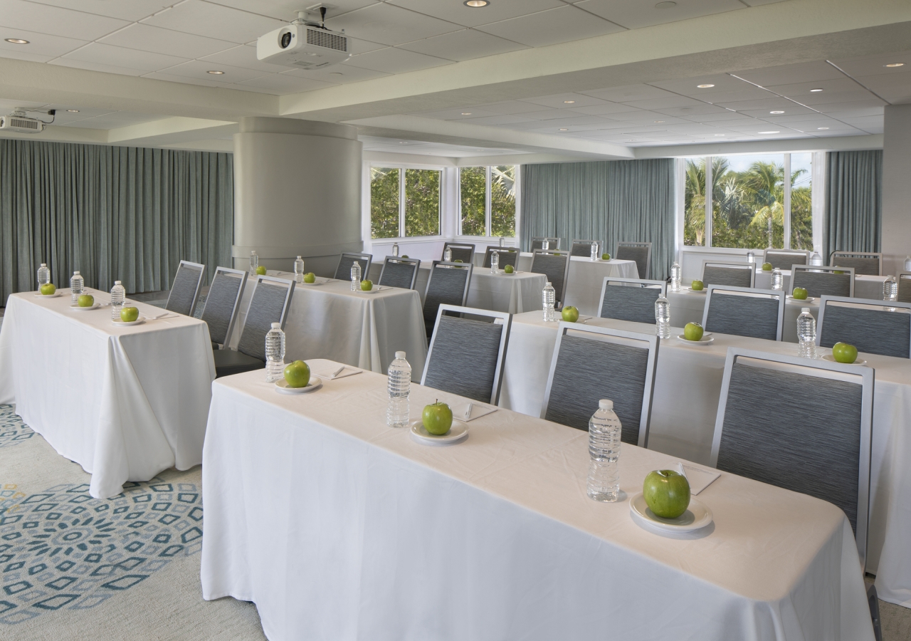 Room with glass walls set up for a meeting.