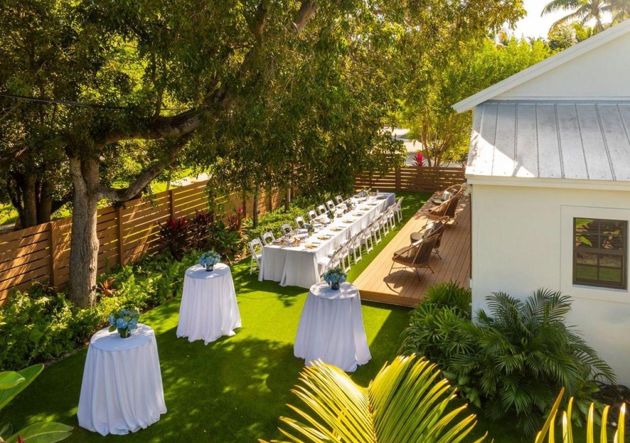 rehearsal dinner set up outdoors on greenery
