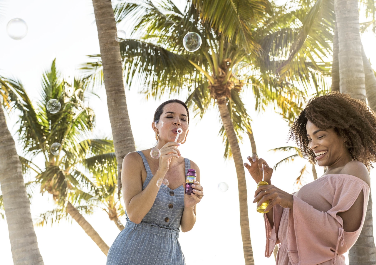 two women blowing bubbles