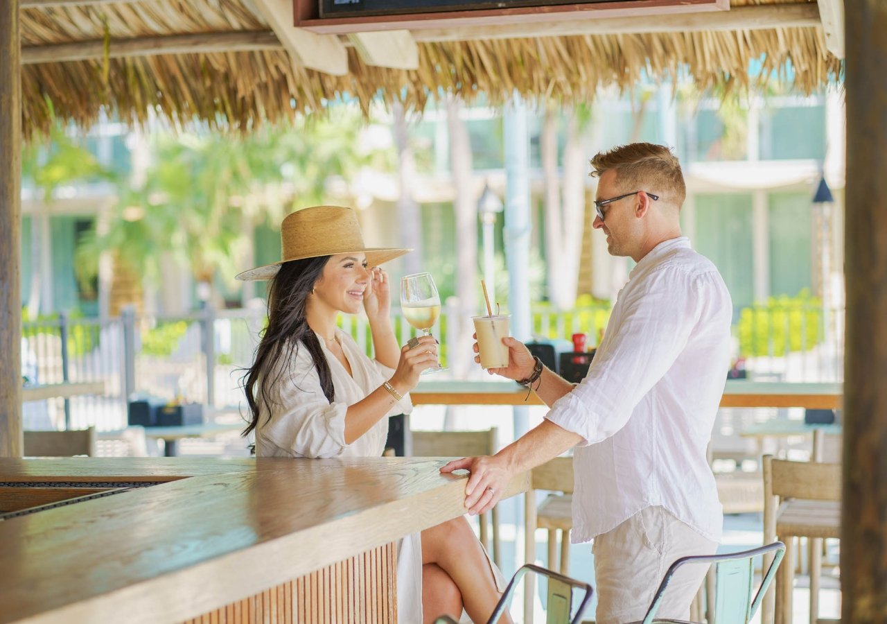 couple have a glass or wine at the outside bar