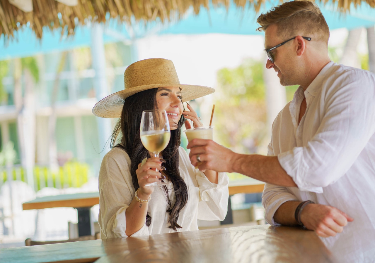 couple have a glass or wine at the outside bar