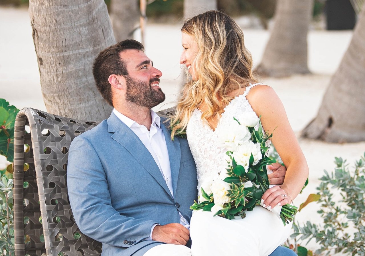 bride sitting on her grooms lap