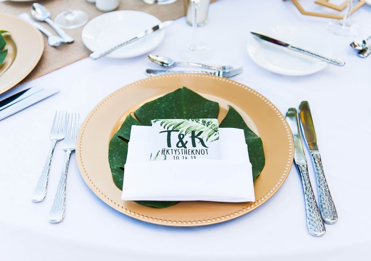 place setting for a wedding dinner with gold plates