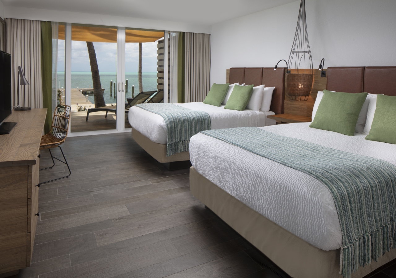 Bedroom with two large beds and a walkout