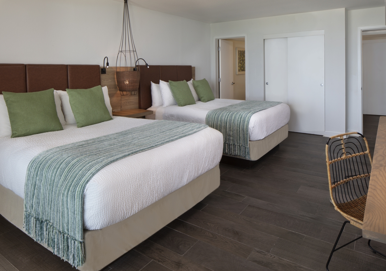 Two queen beds with a workspace