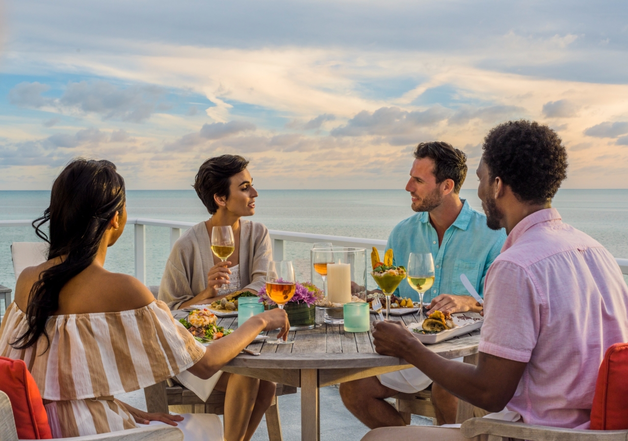 friends gathered around a table having dinner