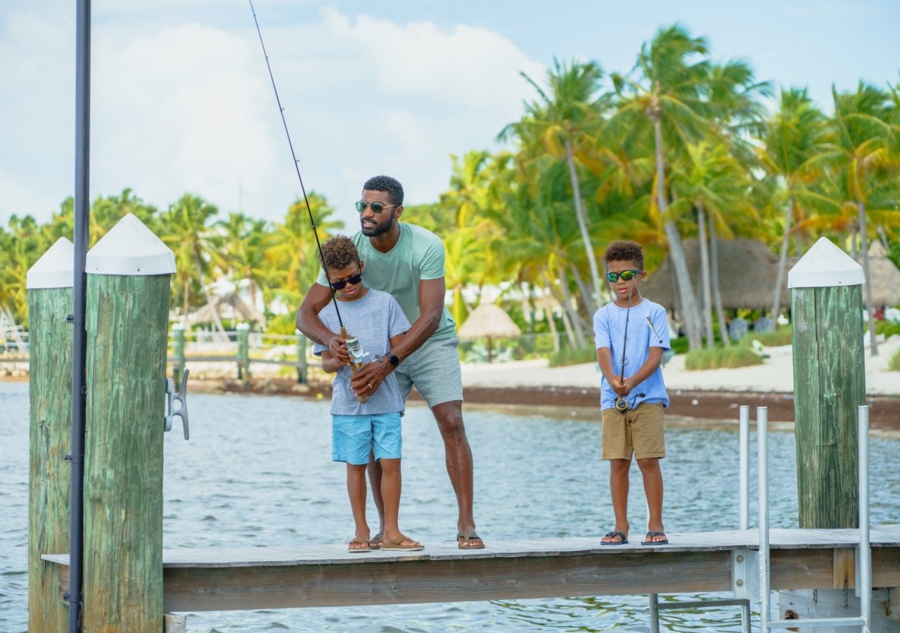 Dad and sons fishing from dock