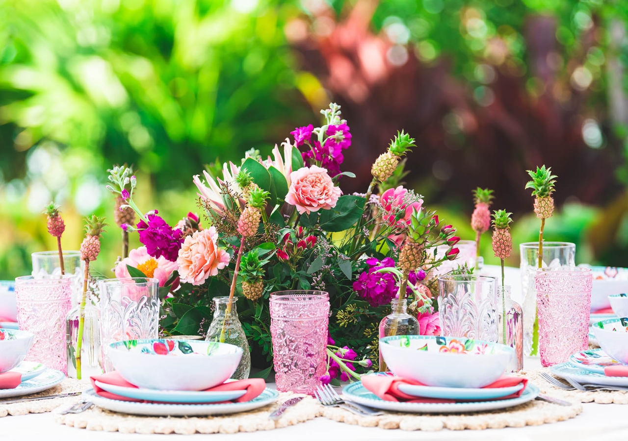 table decorated for a wedding with brightly colored plates and flowers