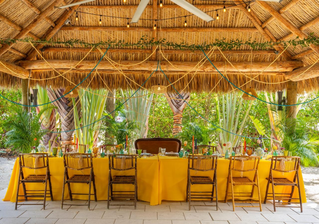 a meeting table decorated with colorful flowers and table cloth 