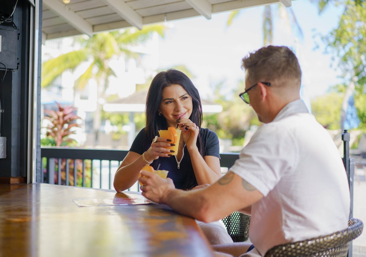 couple sitting at the bar having drinks