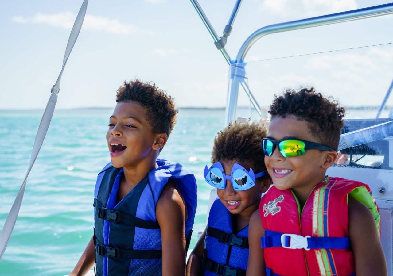children on a boat ,wearing a lifejacket