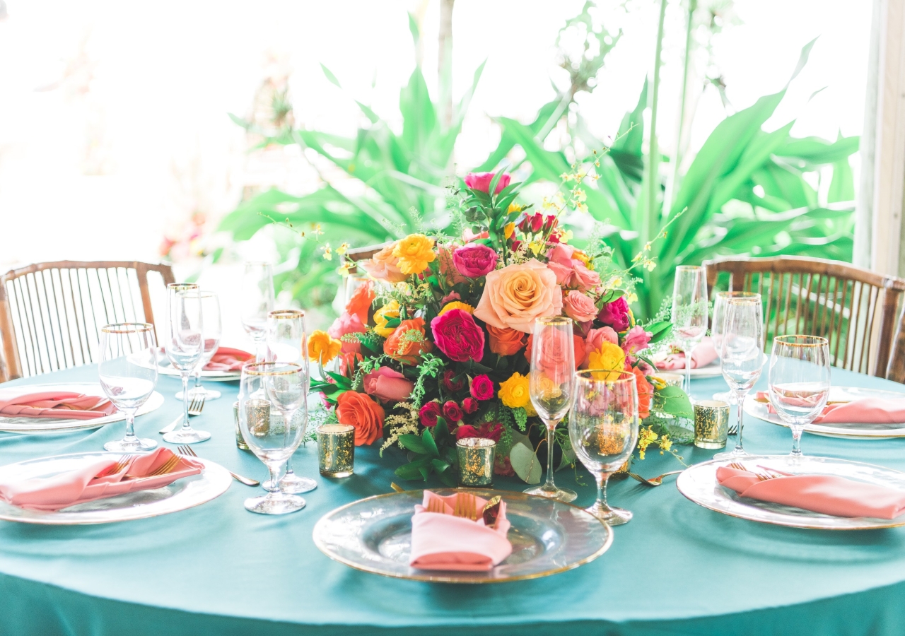table set with colorful china and flowers