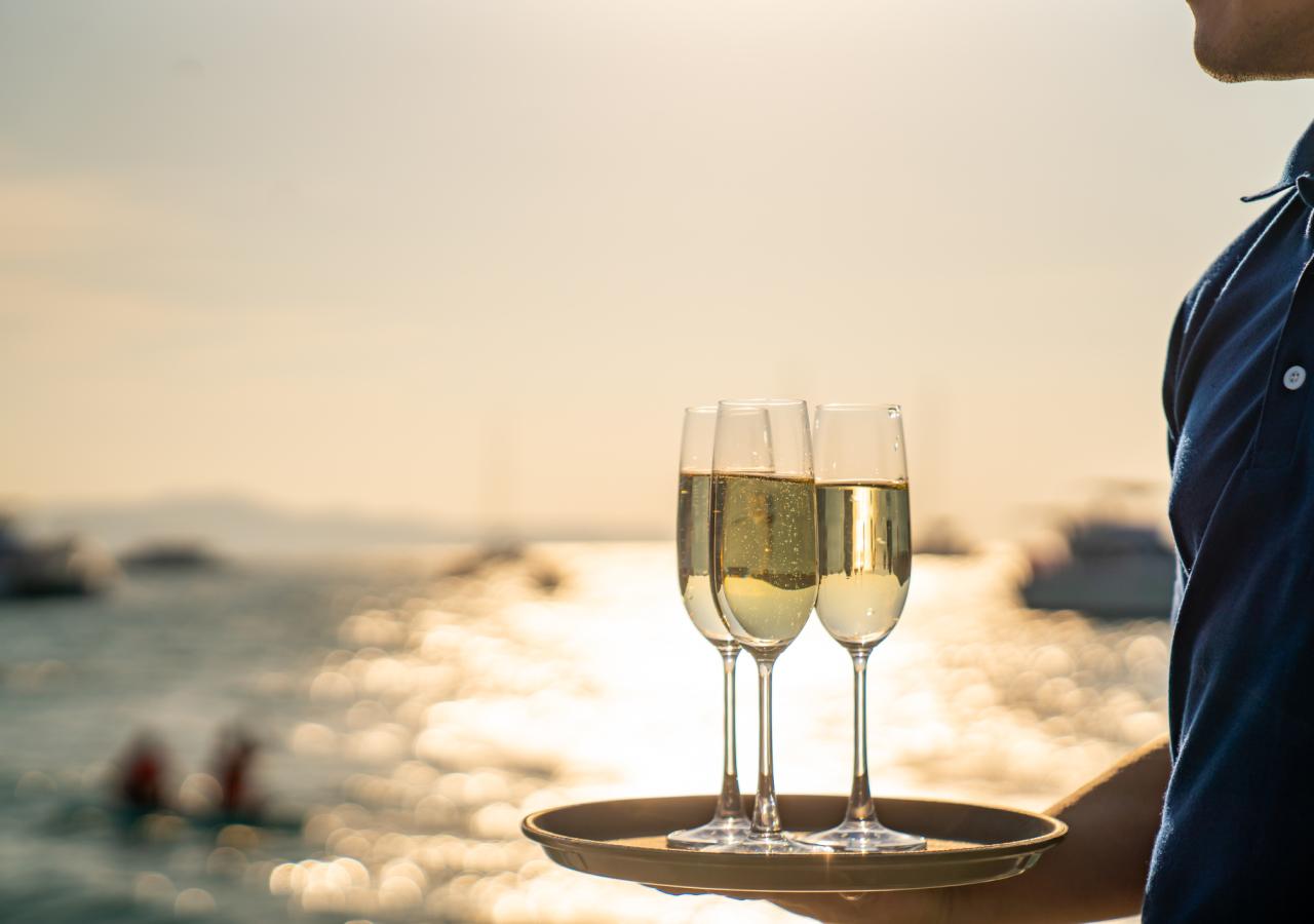 a server holding a tray of champagne 