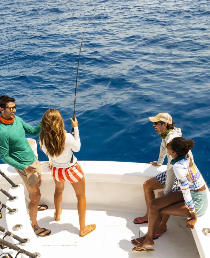 Group of people fishing on a boat in the ocean
