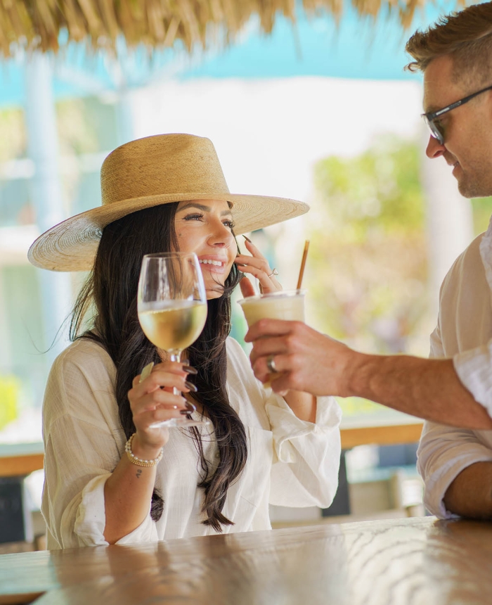 couple have a glass or wine at the outside bar