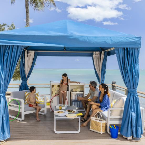 Family enjoying a cabana by the ocean