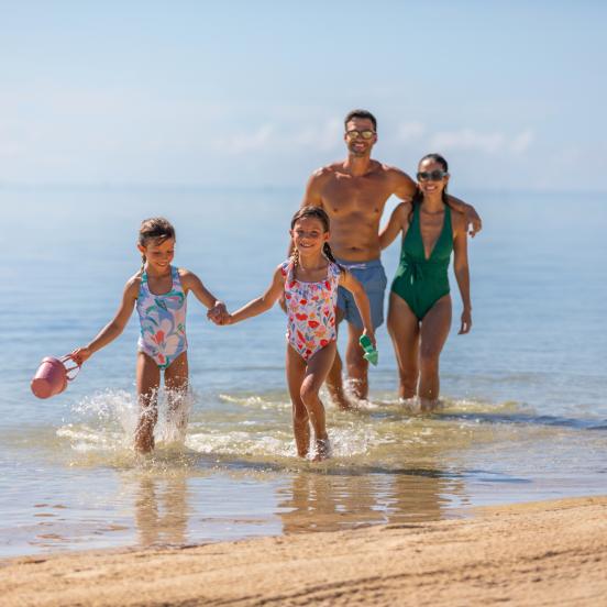 A family walking on the beach in the Keys.