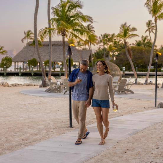 A couple walking at the adults only resort, The Cove, at Three Waters Resort In Islamorada, Florida Keys