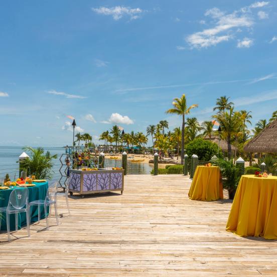 wooden pier with colorful event tables
