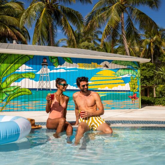 A couple sitting by the pool at La Siesta, an oceanfront resort in the Florida Keys.