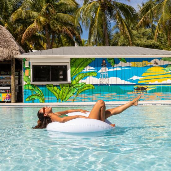 A girl lounging in the pool on an inner tube at La Siesta Resort & Villas in Islamorada, Florida.