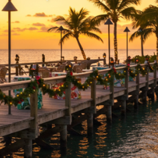 A dock at Three Waters with Christmas lights at sunset.