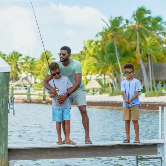 Dad and sons fishing from dock
