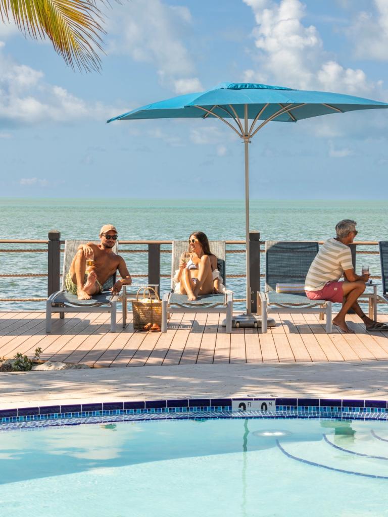 A few people laying out at the pool