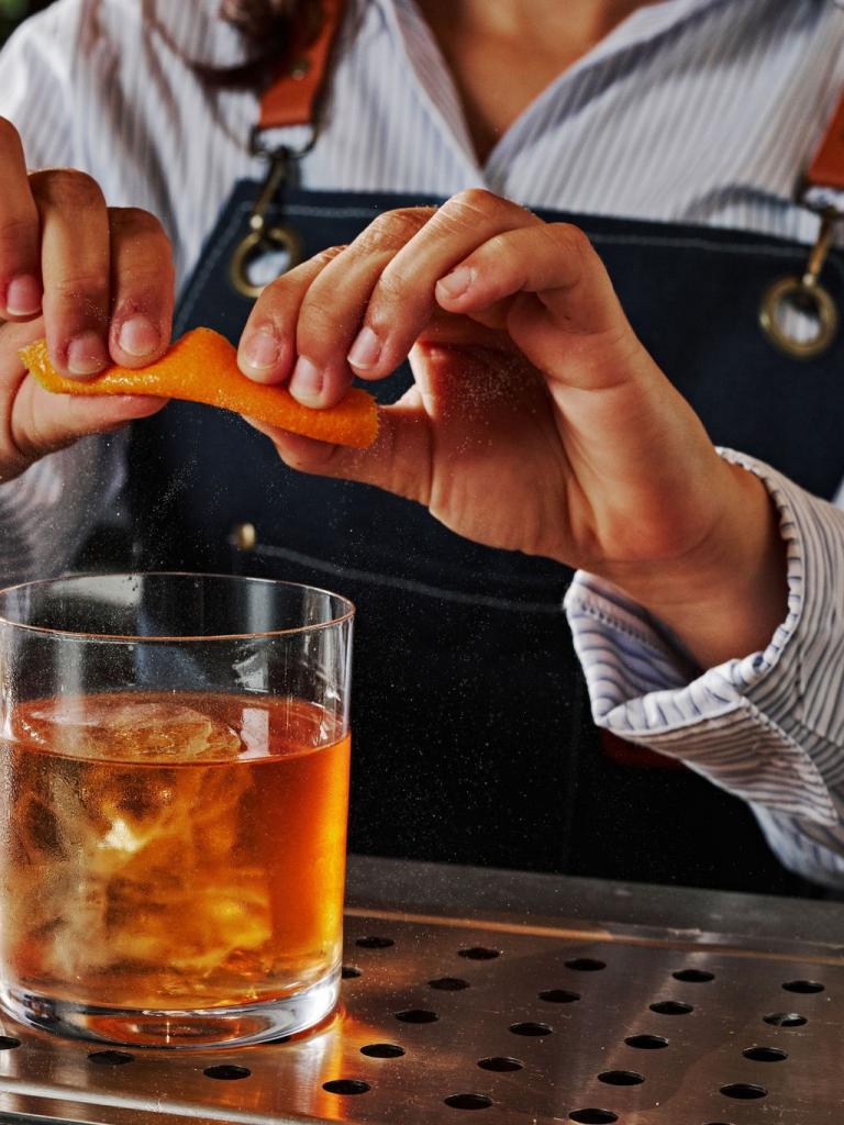 A bartender creating a handcrafted cocktail at Kindler.