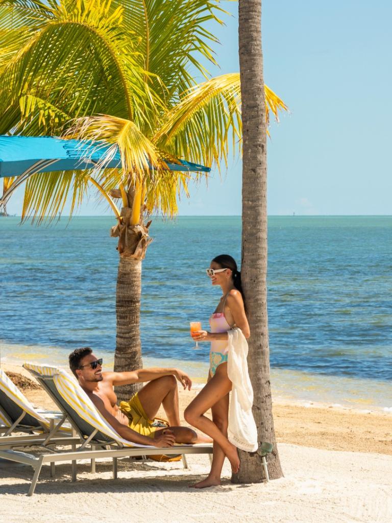 A couple sitting at the beach.