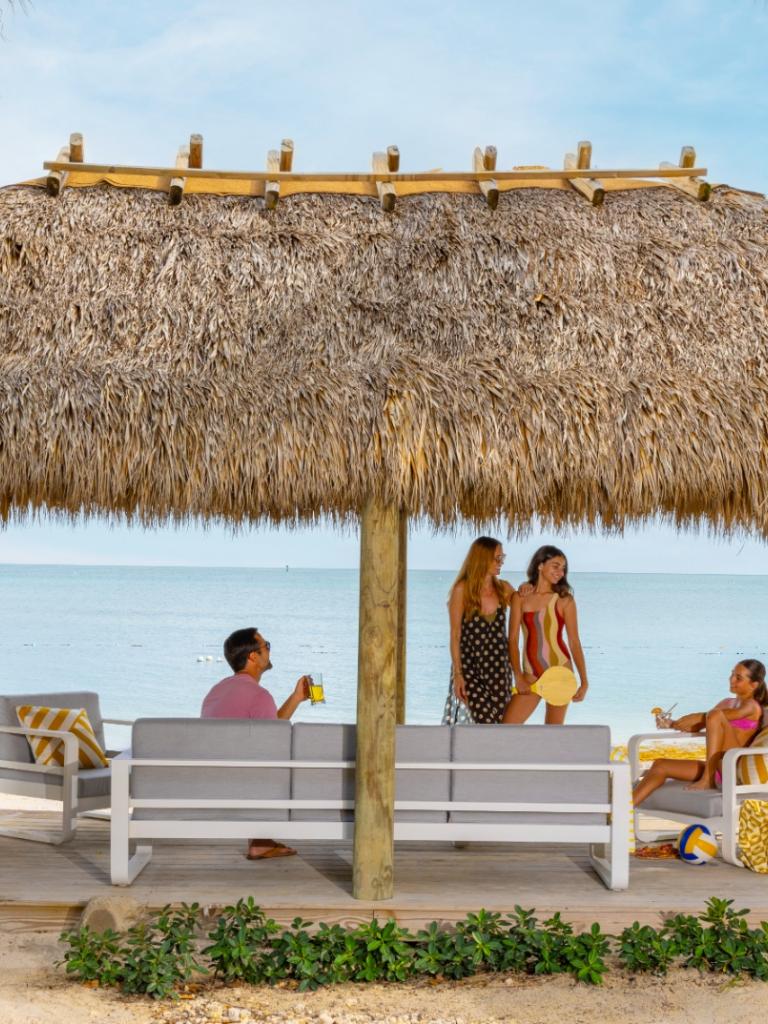 A family hanging out in an oceanfront cabana at Three Waters Resort in Islamorada.