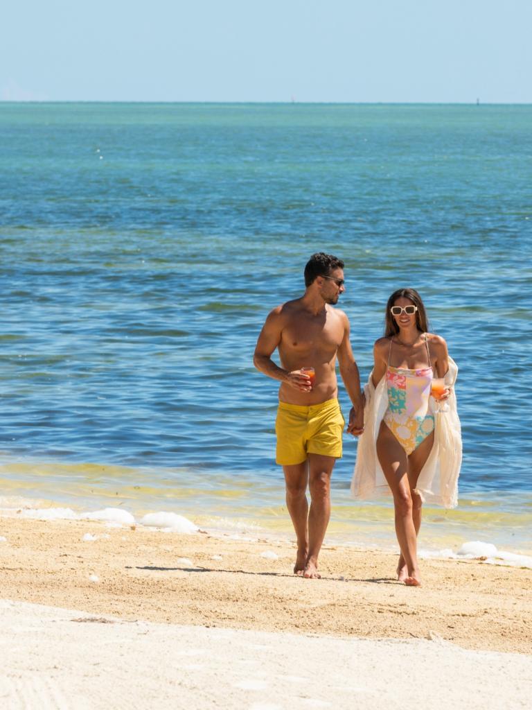 A couple walking on the beach.