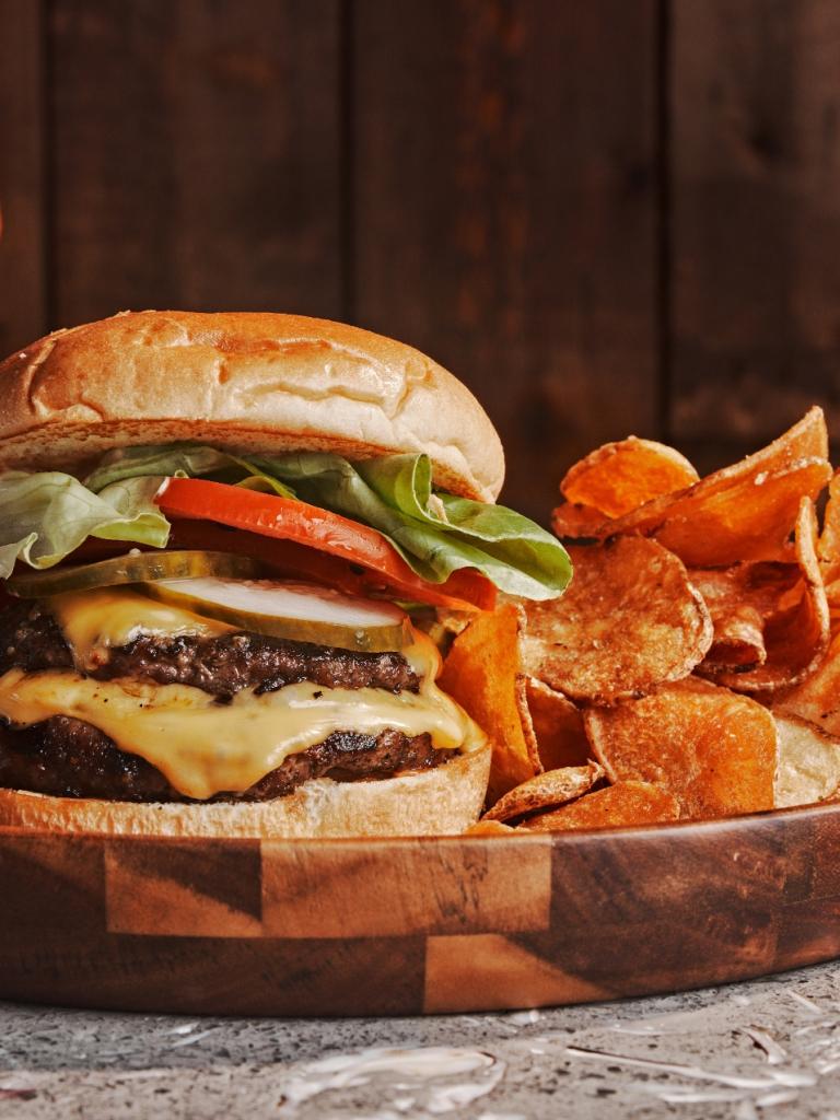 A burger and chips from the original Tiki Bar in Islamorada, Florida at Three Waters Resort & Marina.