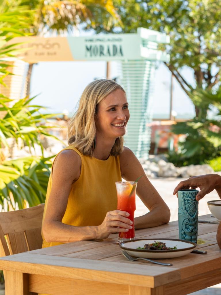 A couple sitting at Tiki Bar talking.