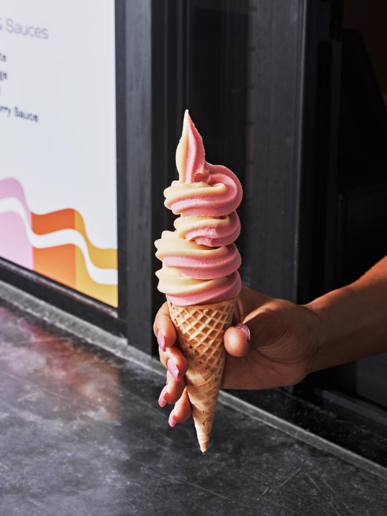A person holding an ice cream cone.