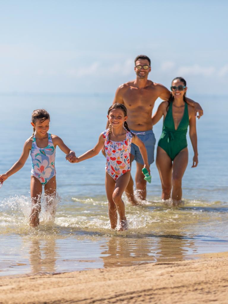 A family walking on the beach in the Keys.