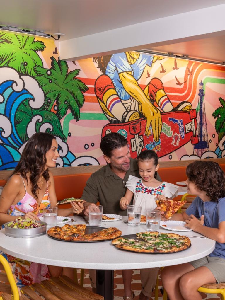 A family sitting and enjoying pizza.
