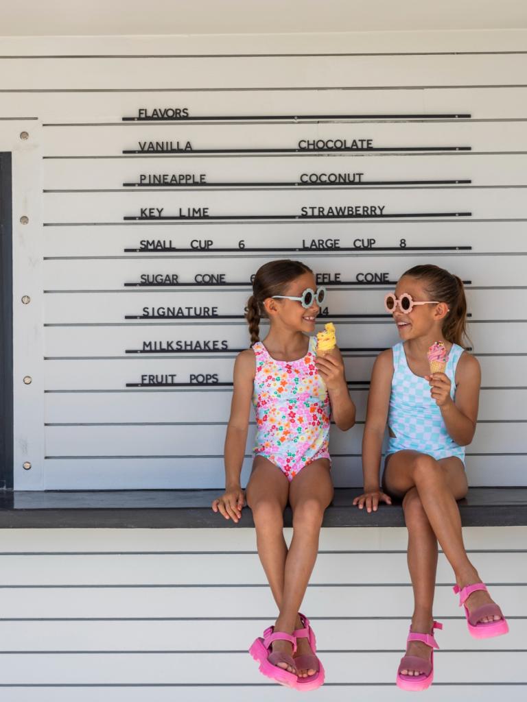 Two little girls enjoying ice cream from Lucky Twist at Three Waters Resort & Marina.
