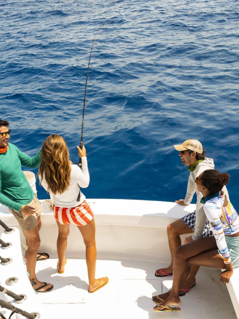 Group of people fishing on a boat in the ocean