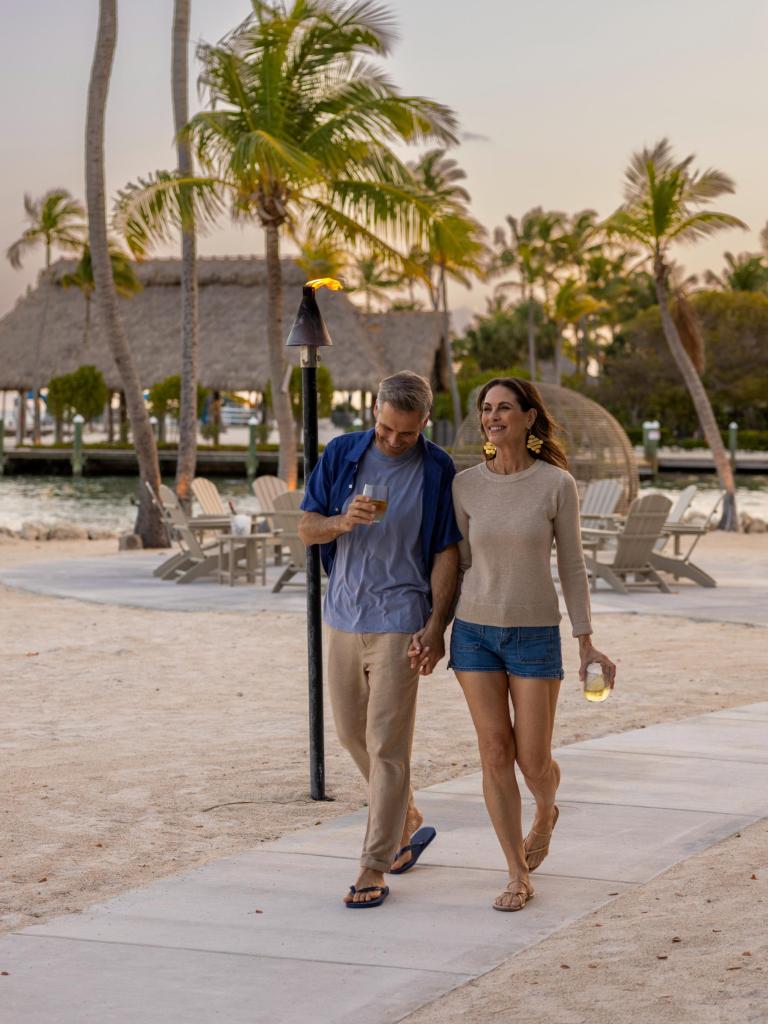 A couple walking at the adults only resort, The Cove, at Three Waters Resort In Islamorada, Florida Keys