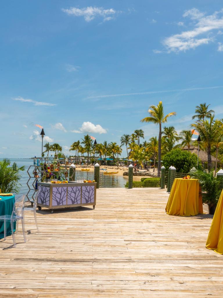 wooden pier with colorful event tables