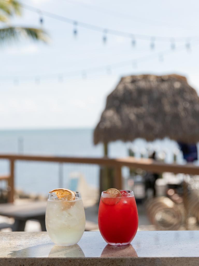 Two cocktails set up on the bar of SIDECAR with ocean views at La Siesta in Islamorada in the Florida Keys.