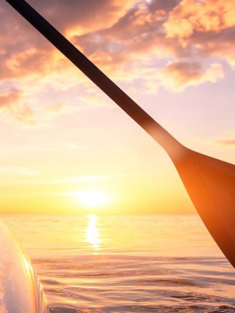 paddling into sunset