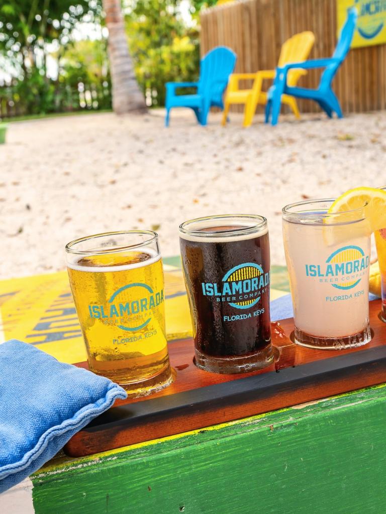 a flight of beer on a corn hole game 