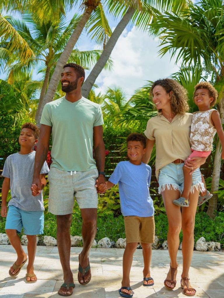 A family with three children walking hand-in-hand at La Siesta Resort & Villas
