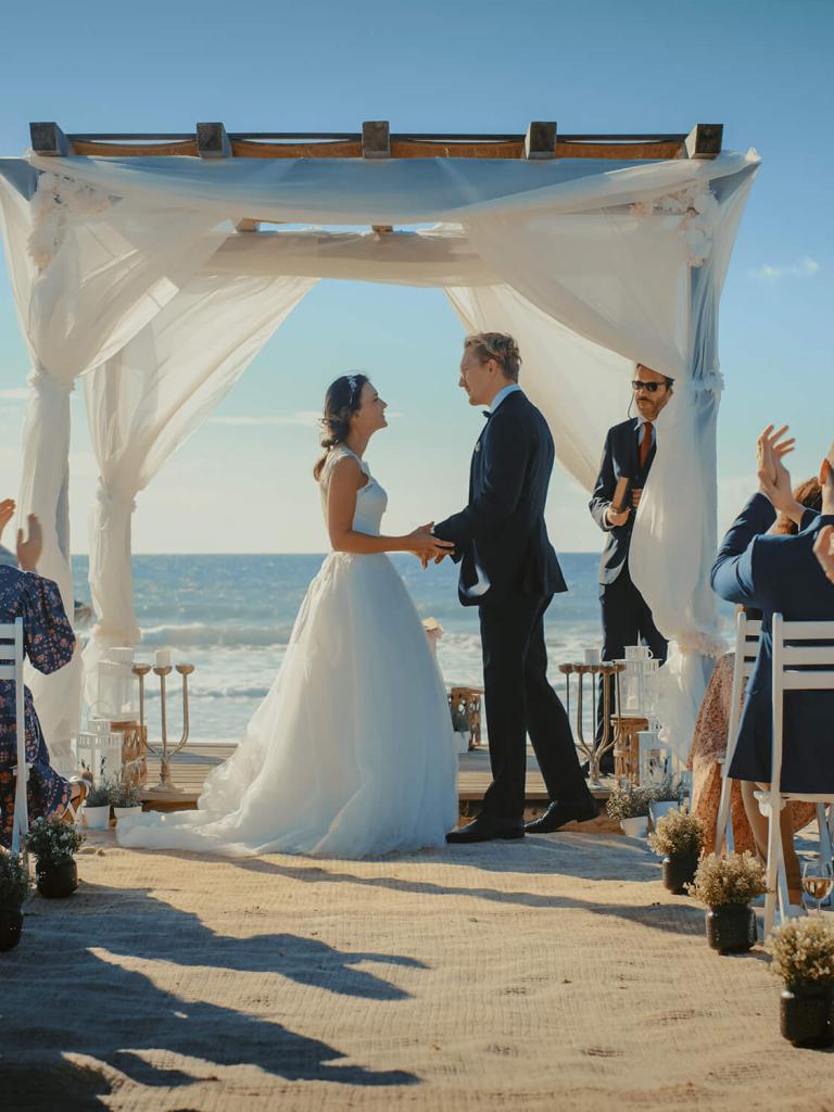 bride and groom getting married on a beack