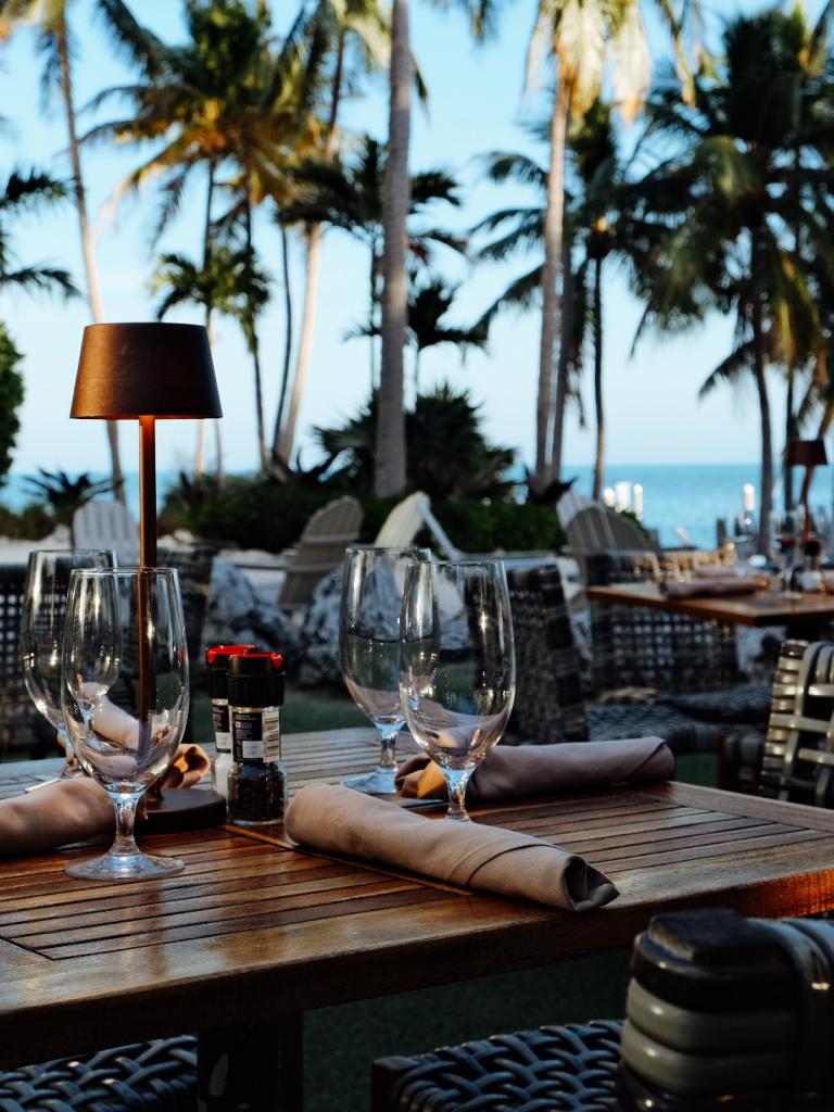 Outdoor dining area a ReelCatch surrounded by fire pits and patio lights. 