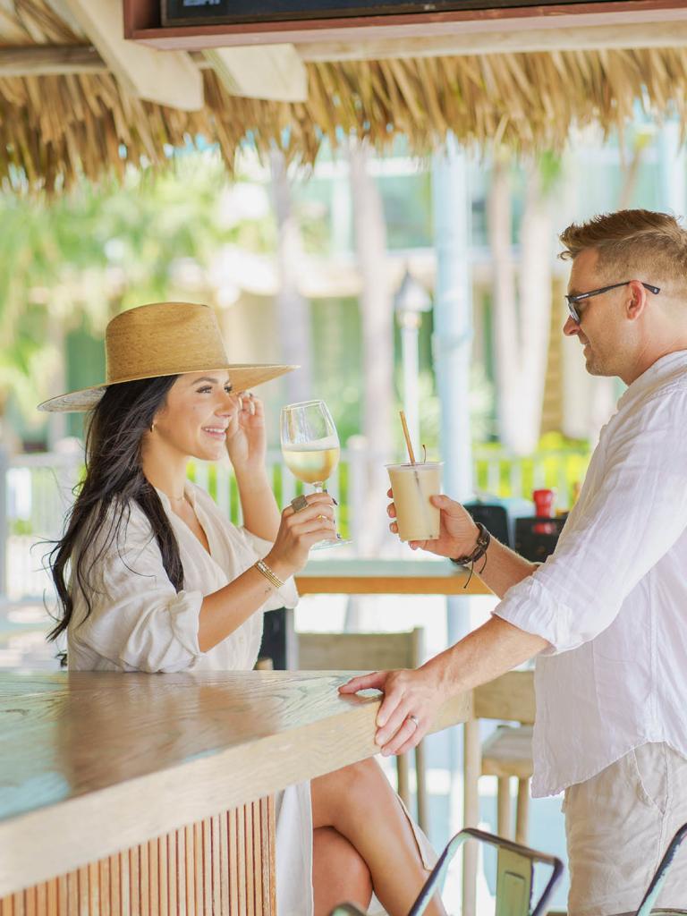 couple have a glass or wine at the outside bar